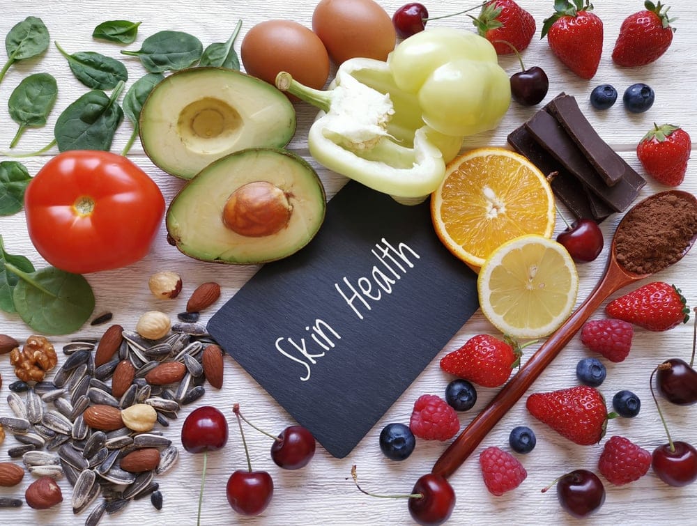 Foods for healthy glowing skin. Assortment of various natural food products high in vitamins and minerals for skin health.