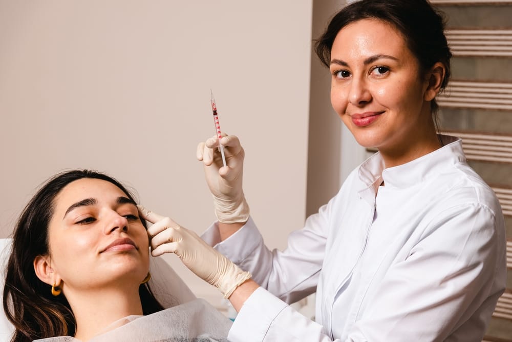 A doctor gives botox injections to prevent wrinkles on the face