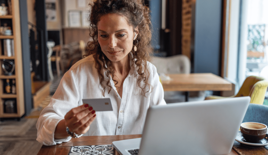 A patient paying a bill online with a credit card and laptop