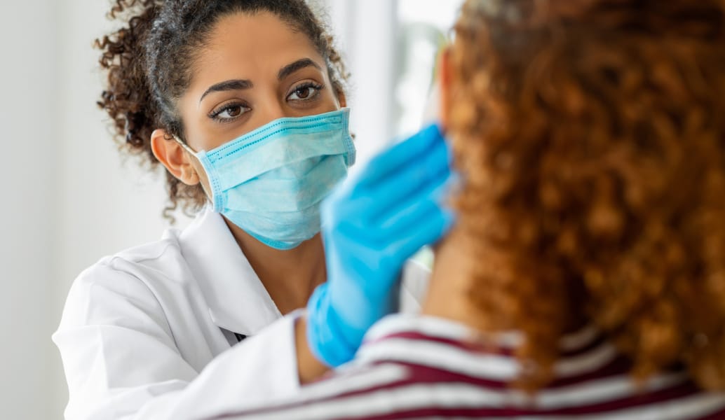 A dermatology provider examining a patient