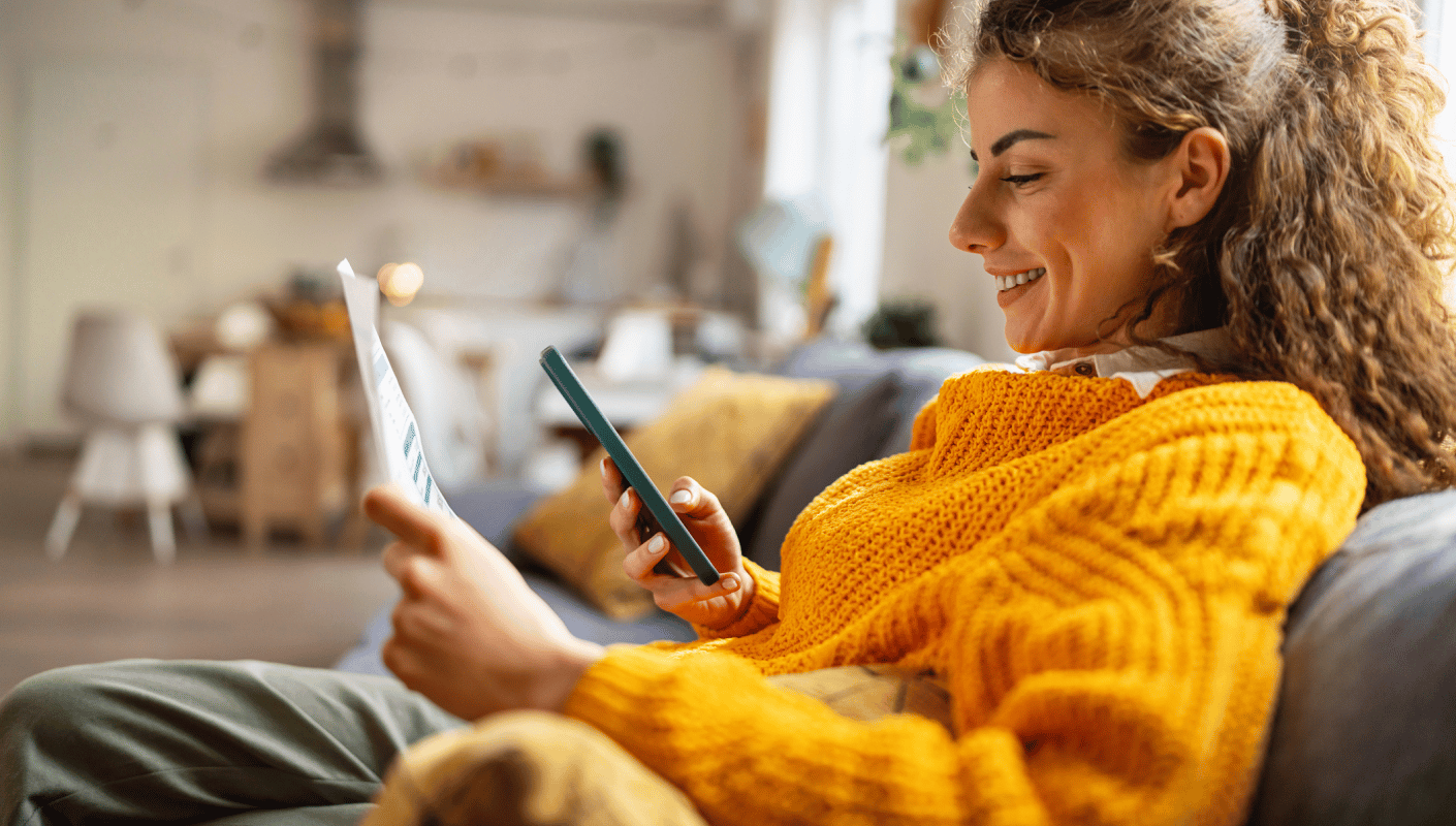 A patient reviewing a bill and paying online from a mobile phone at home