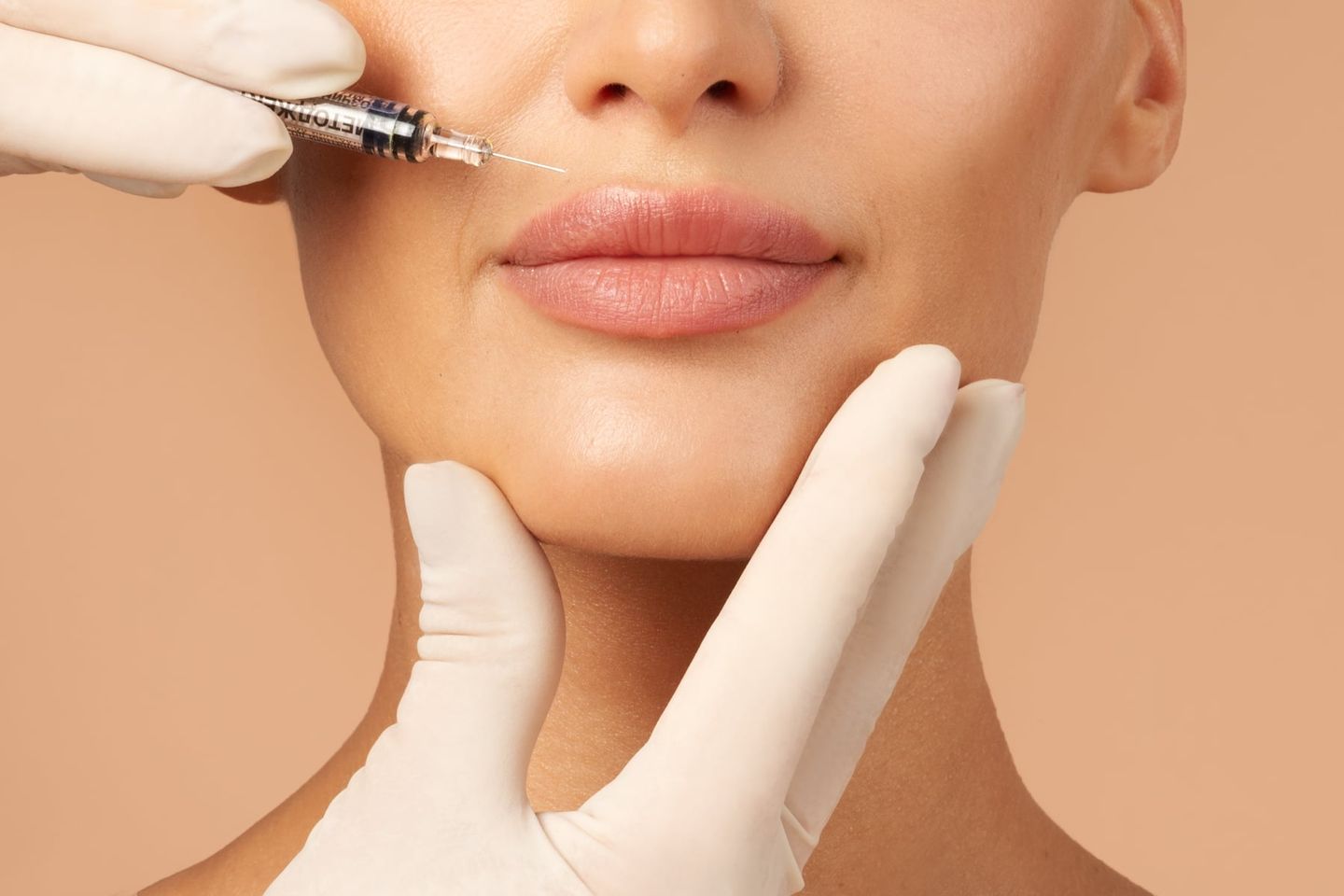 woman receiving lip filler injection