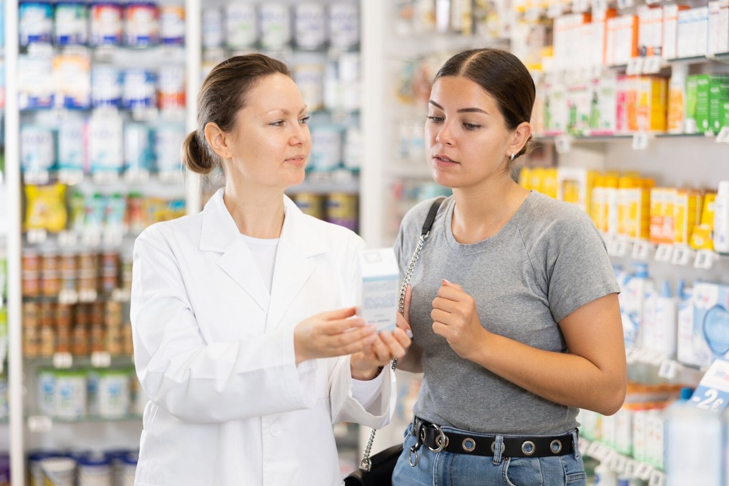 pharmacy visitor getting recommendations from dermatologist on rosacea skincare products