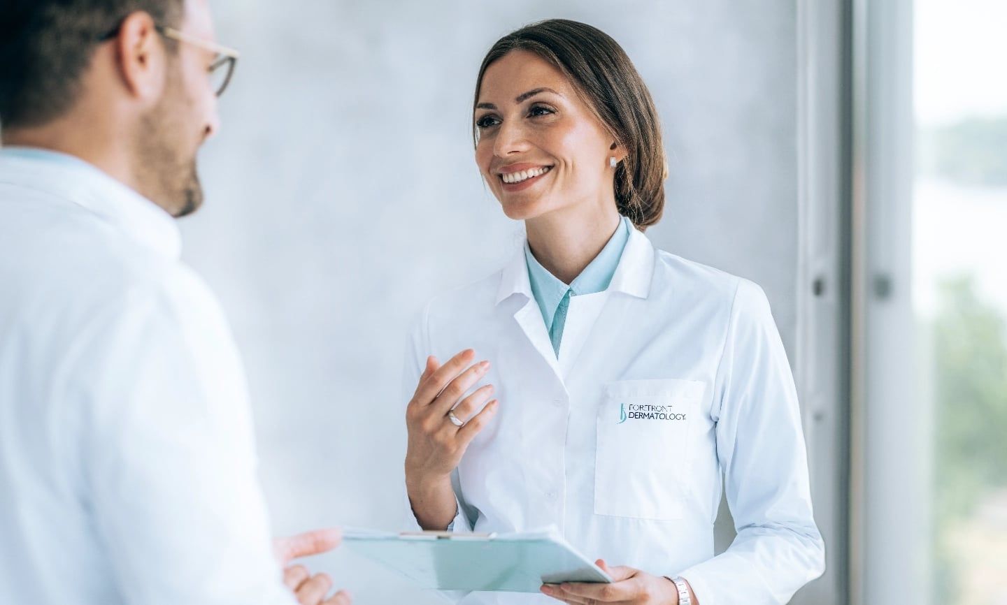 Two Forefront Dermatology physicians in conversation