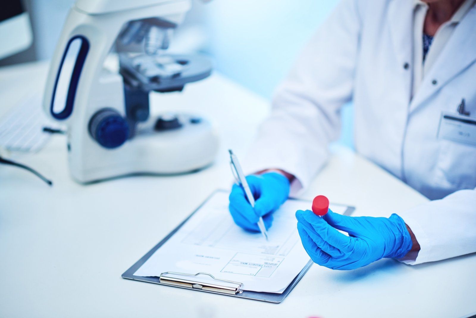 Gloved hands processing a laboratory sample