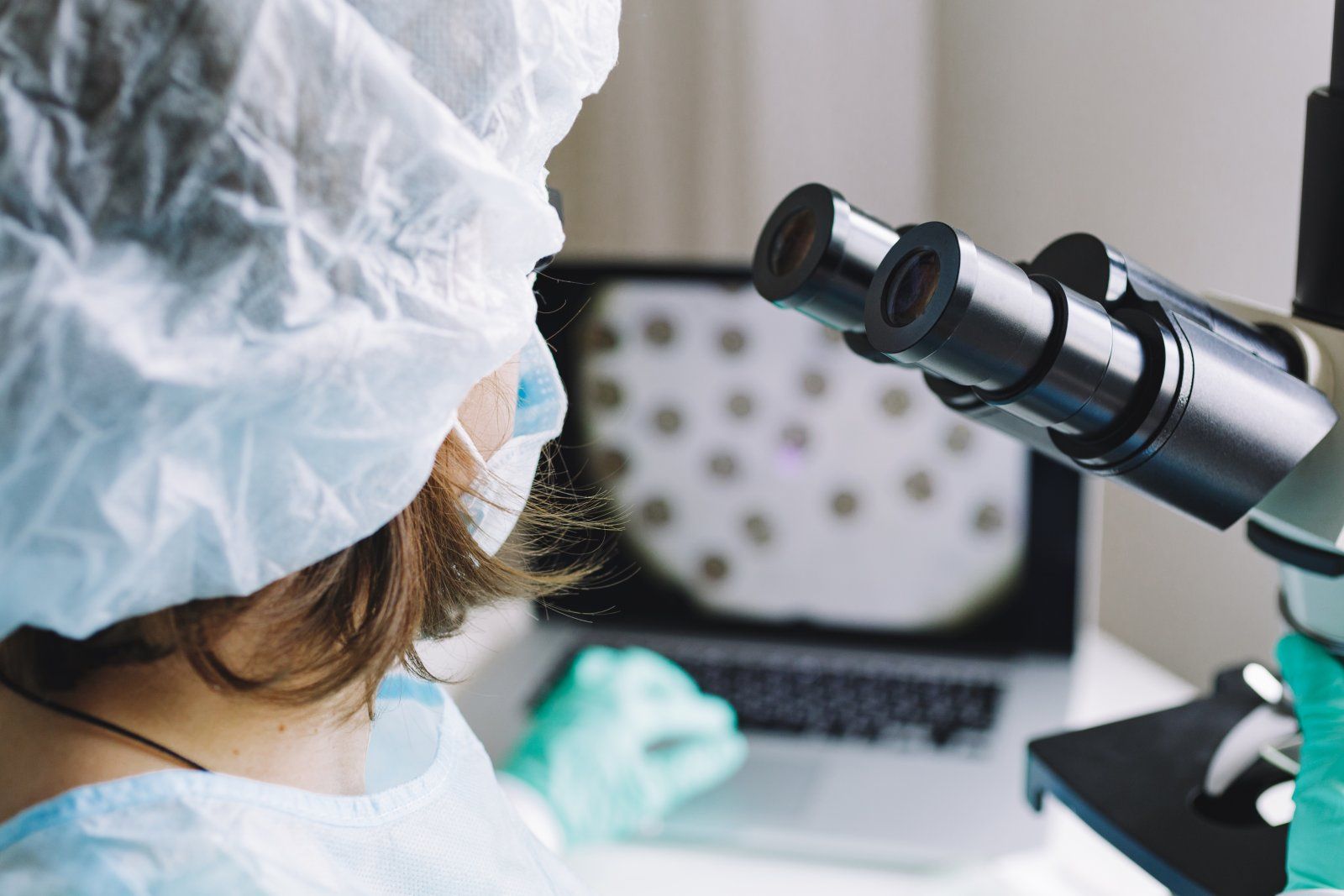 Lab technician using a microscope