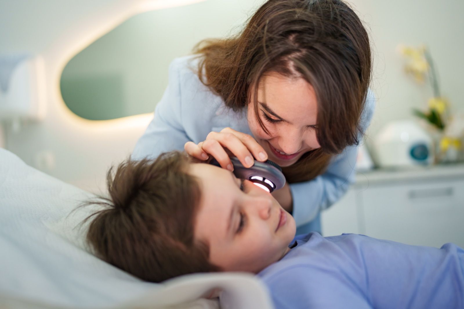 Pediatric dermatologist examining a young child
