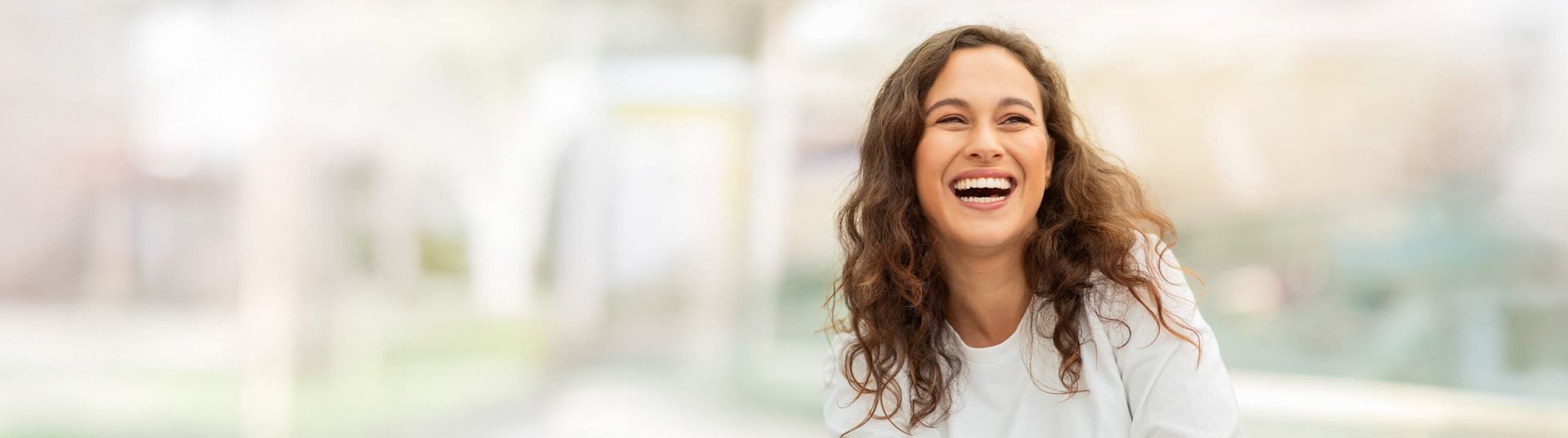 Joyful woman laughing after medical aesthetic treatment