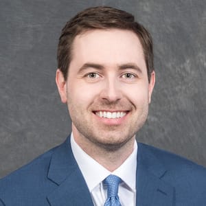 Headshot of Casey Logan, FAAD, MD, board-certified dermatologist at Forefront Dermatology