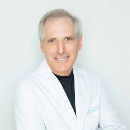 Headshot of Bruce Kerry Barach, MD, board-certified plastic surgeon at Germain Dermatology