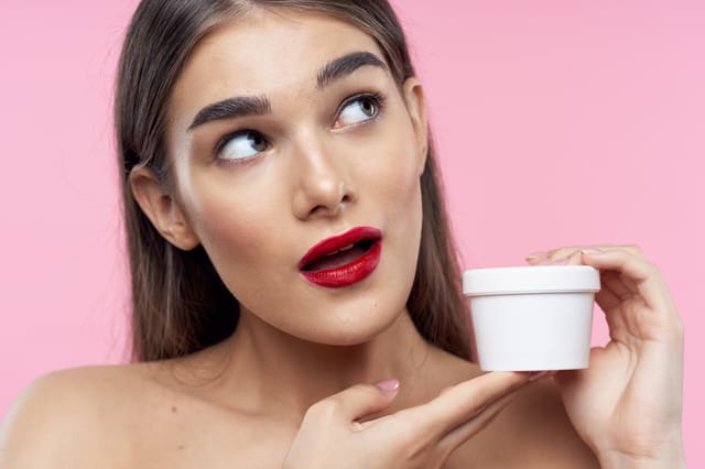 woman holding container of skincare product wondering if it still works