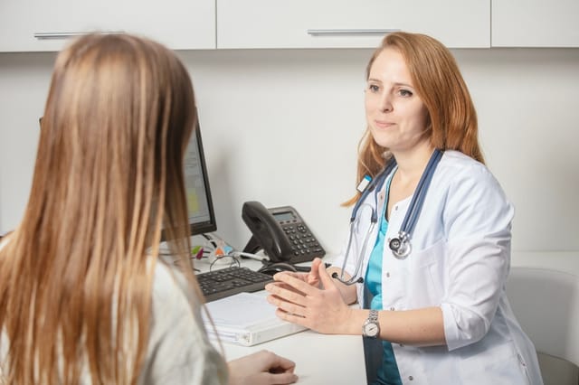 Patient visiting his dermatologist at hospital who takes signs and symptoms of skin and rules out other internal disease