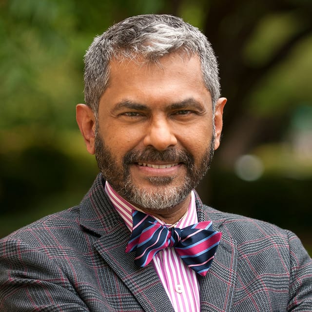 Headshot of Abraham Kuruvilla, FAAD, MD, board-certified dermatologist at Forefront Dermatology