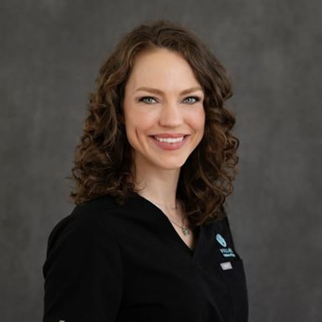 Headshot of Julia Tauscher, FAAD, MD, board-certified dermatologist at Village Dermatology