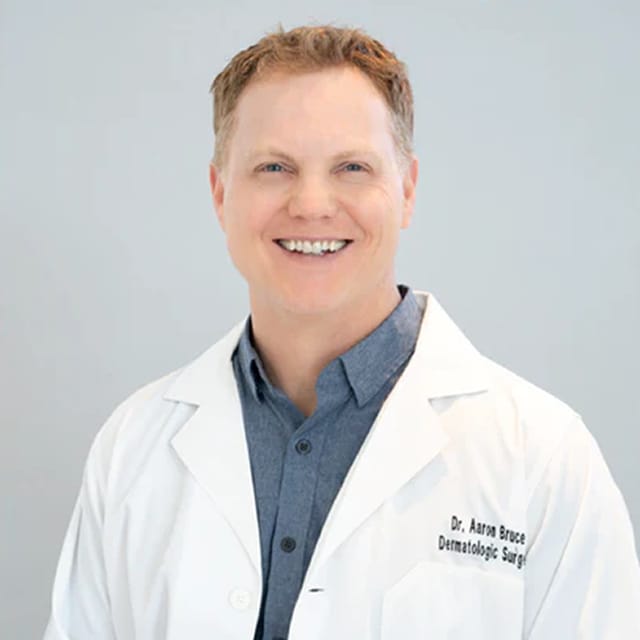 Headshot of Aaron Michael Bruce, DO, FAAD, FACMS, FAOCD, board-certified dermatologist at Montana Skin Cancer and Dermatology Center P.C., dba SkinCare MT