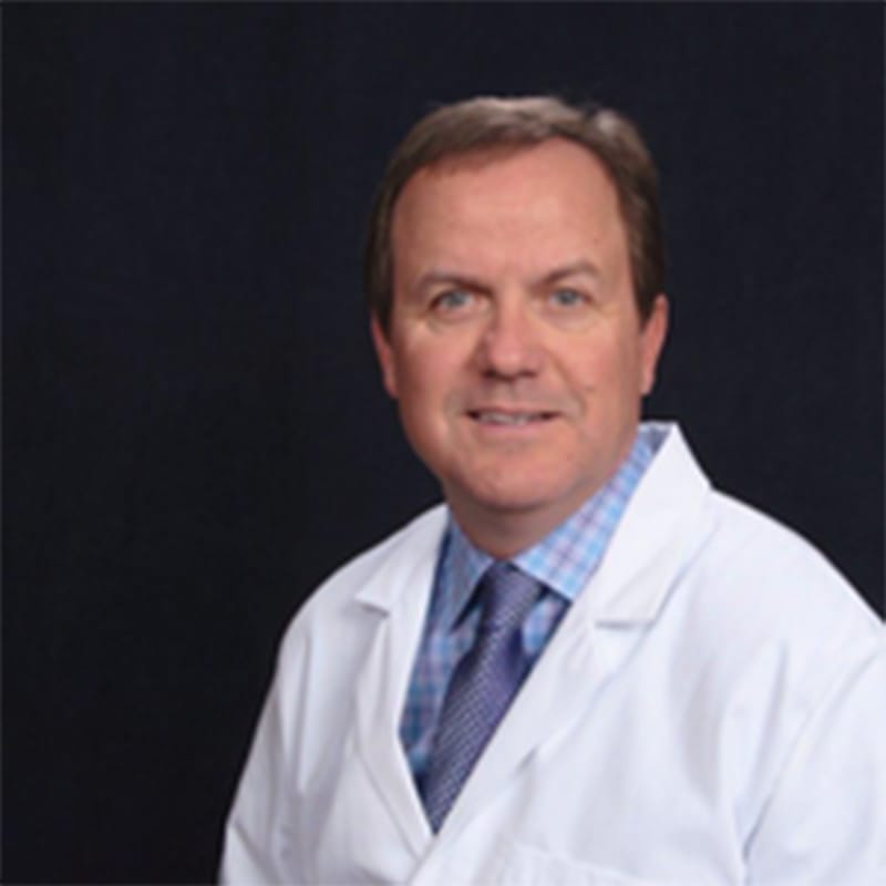 Headshot of Brad Amos, FAAD, MD, board-certified dermatologist at Forefront Dermatology