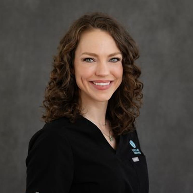 Headshot of Julia Tauscher, FAAD, MD, board-certified dermatologist at Village Dermatology