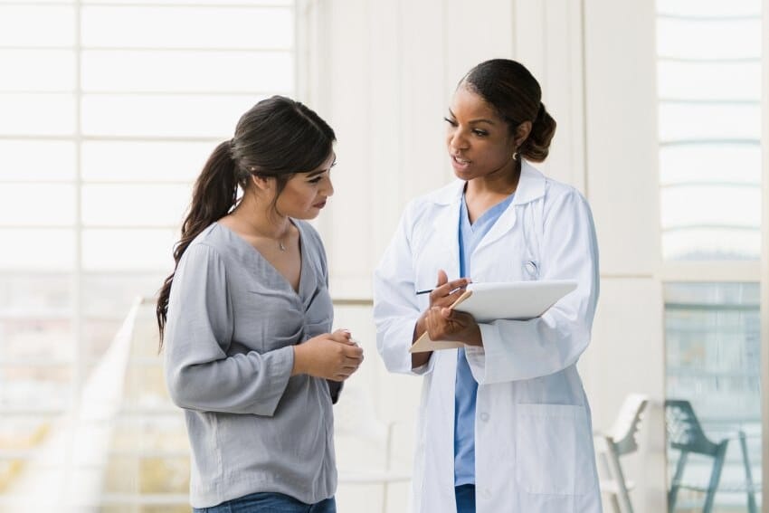 A patient discussing care with a Forefront Dermatology provider