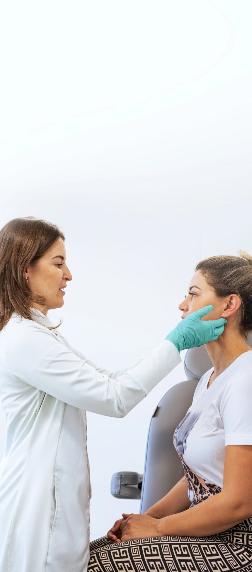 Board-certified dermatologist examining a patient