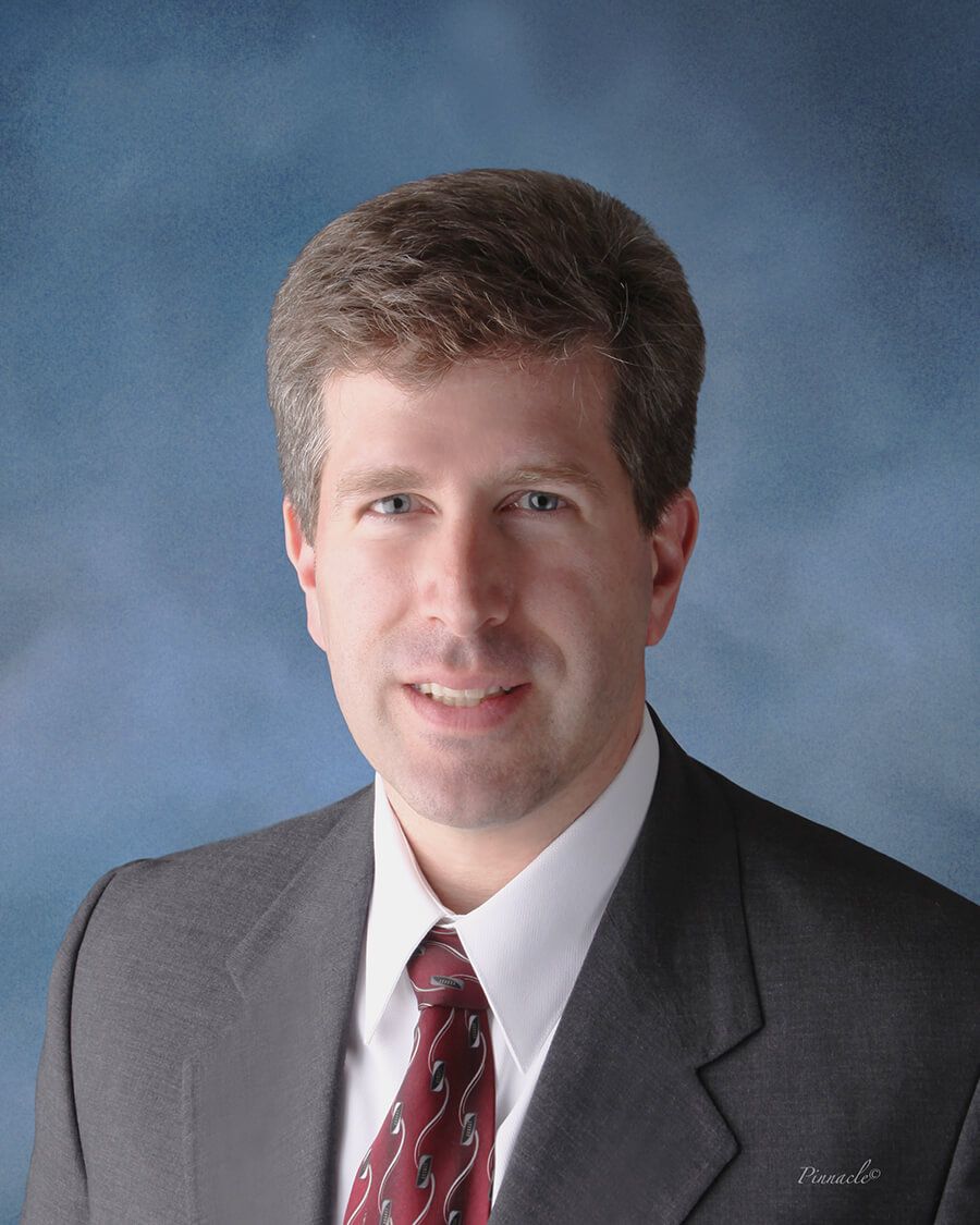 Headshot of John Pujals, FAAD, MD, board-certified dermatologist at Forefront Dermatology