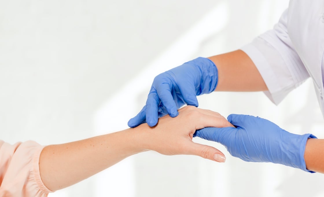 dermatologist hand checking for symptoms